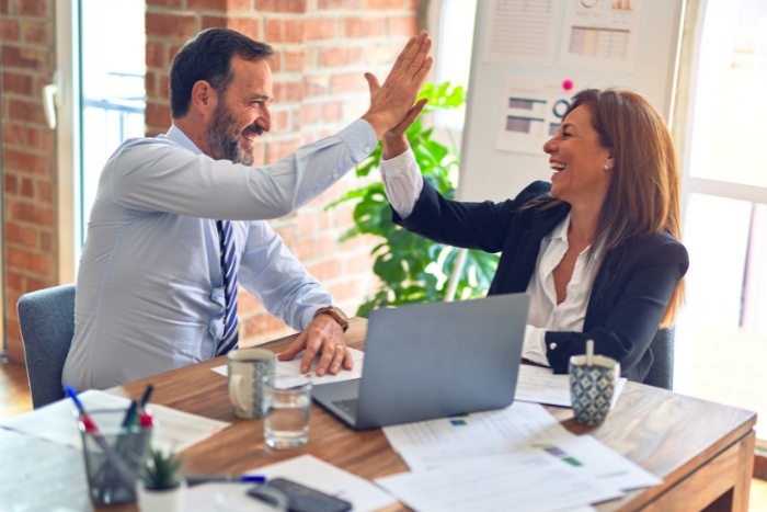 two business people high five each other